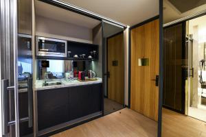 a kitchen with a sink and a microwave at Broyt Hotel in Istanbul