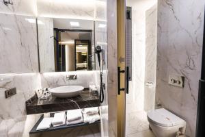 a bathroom with a sink and a toilet and a mirror at Broyt Hotel in Istanbul