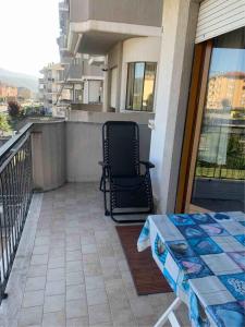 a chair sitting on the balcony of a building at IL SENSO DI LIBERTA' in Rieti +1 photo