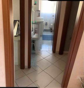 a hallway of a bathroom with a sink and a toilet at IL SENSO DI LIBERTA' in Rieti