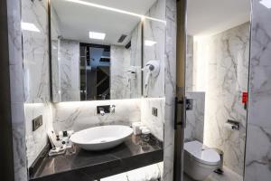 a white bathroom with a sink and a toilet at Broyt Hotel in Istanbul