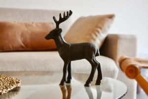 a small figurine of a deer on a table at Apartment Arvenwald in Kandersteg