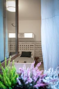 a view of a bedroom with a bed and a mirror at ZumaApartment in Košice
