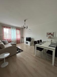 a living room with a couch and a table at Apartments ”Enkeli” in Kotka