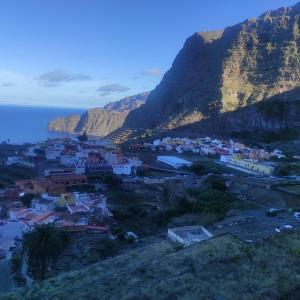 a town on a hill next to the ocean at CASA ROSAMAR in Agulo