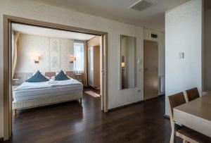 ティハニにあるEcho Residence All Suite Hotelのベッドルーム1室(青い枕のベッド1台付)