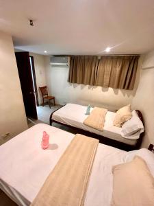 a hotel room with two beds and a window at Cubic P 1902 in Cebu City