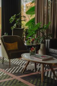 a living room with a couch and a coffee table at The Reserve - The Leading Hotels of the World - Savoy Signature in Funchal
