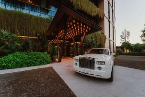 a white car parked in front of a building at The Reserve - The Leading Hotels of the World - Savoy Signature in Funchal
