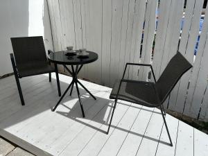 a table and two chairs sitting on a porch at Mezonet Svítkov 21 in Pardubice