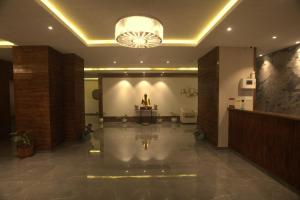 a large lobby with a chandelier in a building at Magpie Libing Grand (MG Marg) in Gangtok