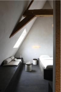 a attic bedroom with two beds and a skylight at High end private room with private bathroom in Ghent