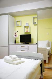 a bedroom with a bed and a tv in it at D&J Apartment Zadar in Zadar