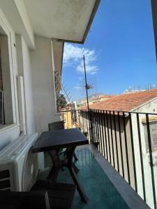 a balcony with a table and a view of a roof at 100 PASSI Politeama in Palermo