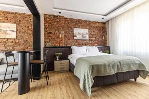 a bedroom with a bed and a brick wall at Sea View Flat w Balcony Near Beylerbeyi Palace in Istanbul