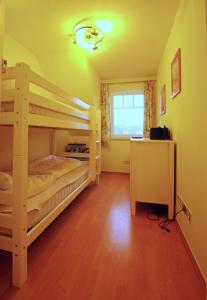 a bedroom with two bunk beds and a window at Ataraxia in Insel Poel