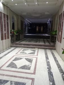 a hallway with a tile floor in a building at El Mohandesen in Cairo