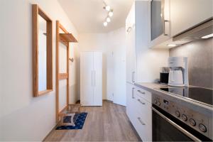 a kitchen with white cabinets and a counter top at Wohnpark am Mühlenteich App 14 in Timmendorfer Strand