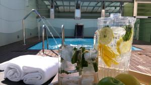 a table with a glass of water and a bottle of lemon at Ako Suites Hotel in Barcelona