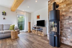 a living room with a fireplace and a couch at Tischneck Chalets in Hardt