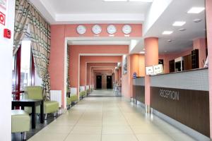 a corridor of a hospital with clocks on the walls at IT Time Hotel in Minsk