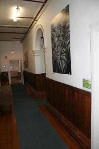 a large room with a large wall with paintings on it at Arthouse Hostel in Launceston