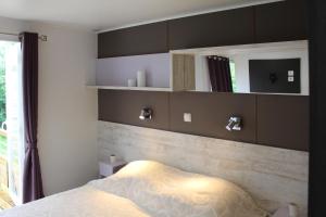 a bedroom with a bed and some shelves at Bontempo Village La Yole in Saint-Jean-de-Monts