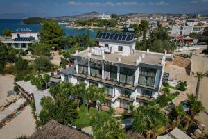 an aerial view of a building with a solar roof at HOTEL DENOEL in Ksamil