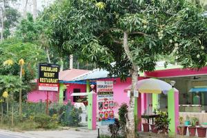 a pink building with a sign in front of it at Dream Land Resort Havelock in Havelock Island +3 photos