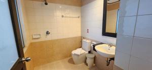 a bathroom with a toilet and a sink at Eden Park in Patong Beach