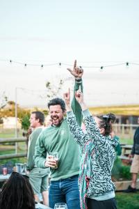 a man and a woman raising their hands in the air at Mawgies in Saint Ervan