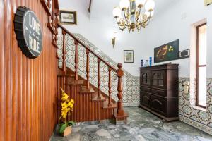 a staircase in a house with a clock on the wall at The whole villa, near a large park and a quiet beach in Barreiro