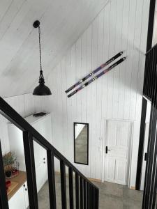 una escalera en una casa con una luz colgando del techo en Szczurze wzgórze, en Zachełmie
