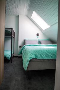 a bedroom with a bed and a skylight at Bienvenue dans le cyan 2 à 6 couchages in Cholonge