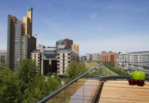 a balcony with a view of a city with tall buildings at Grimm's Potsdamer Platz in Berlin