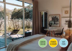 a bedroom with a bed and a large window at Gite in Franschhoek