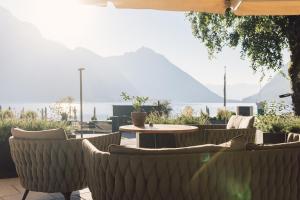 a patio with chairs and a table with a view at Seehotel Einwaller - adults only in Pertisau