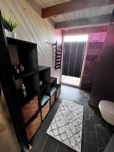 a bathroom with a toilet and a window in a room at Feel the breeze - cozy luxury in Elva