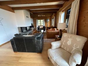a living room with a couch and a chair at Chalet Rose Bay in Leysin