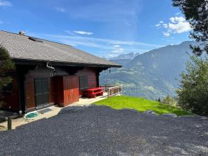 a house on a hill with a view of mountains at Chalet Rose Bay in Leysin