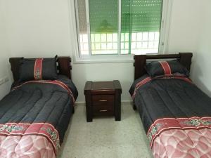 two beds sitting next to each other in a room at BnB La Luna Entire Apartment in Jericho