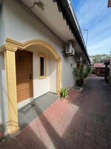 a building with a door and a brick driveway at Sandy Beach Resort By Casa Loma in Pantai Cenang