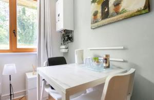 a white table and chairs in a room with a window at Spacious Room with Relaxing View in Dublin