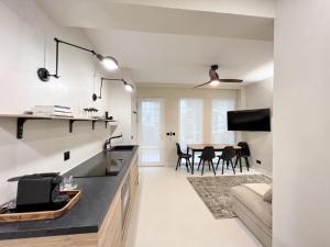 a kitchen and living room with a table and a couch at Superb Apartment Palais Royal Louvre Museum in Paris