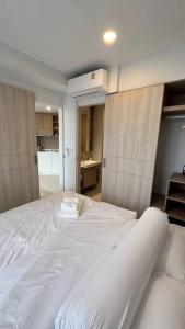 a bedroom with a large white bed in a room at Laguna Sky Park Corner 1 Bedroom in Bang Tao Beach