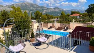 a view from the balcony of a villa with a swimming pool at Villa Dalma in Čilipi