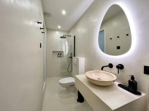 a bathroom with a sink and a toilet and a mirror at Superb Apartment Palais Royal Louvre Museum in Paris