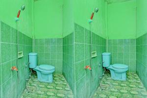 uma casa de banho com 3 WC e paredes em azulejo verde em SPOT ON 93029 Pondok Wisata Sabar Menanti 2 em Bantul