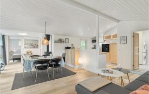 a living room and kitchen with a table and chairs at Lovely Home In Strandby With Kitchen in Strandby
