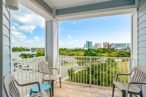 a balcony with chairs and a view of a harbor at Grande Caribbean 326 in Orange Beach